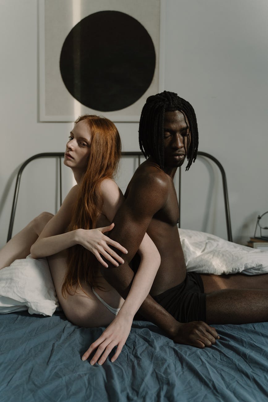 A person sits cross-legged in a sunlit room, practicing self-love and mindfulness with a calm, empowered expression.