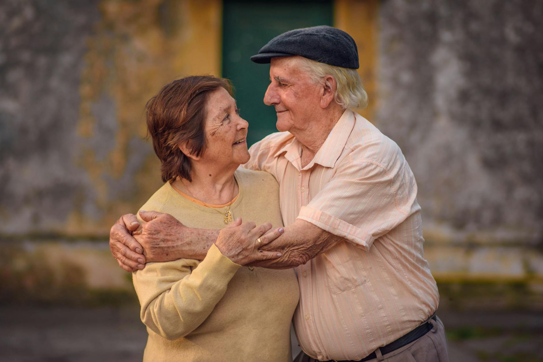 Two people sitting on a bench at sunset, engaged in a meaningful conversation to build emotional connection.